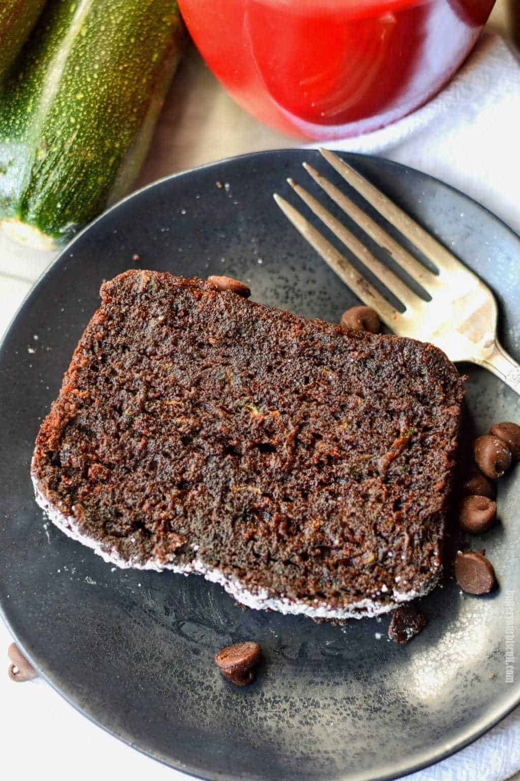 chocolate zucchini bread on a black plate with a fork