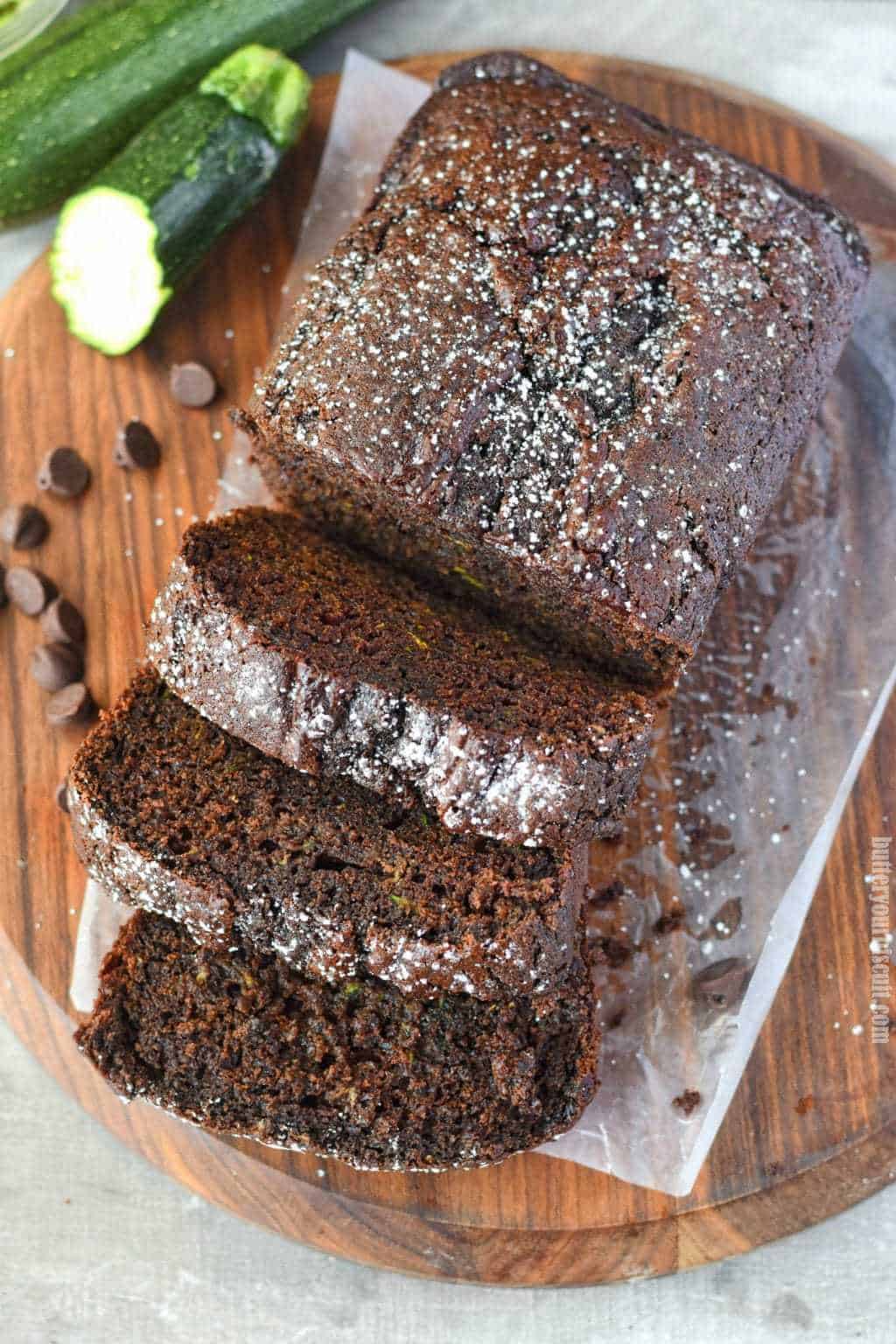 chocolate zucchini bread sliced on a cutting board with chocolate chips