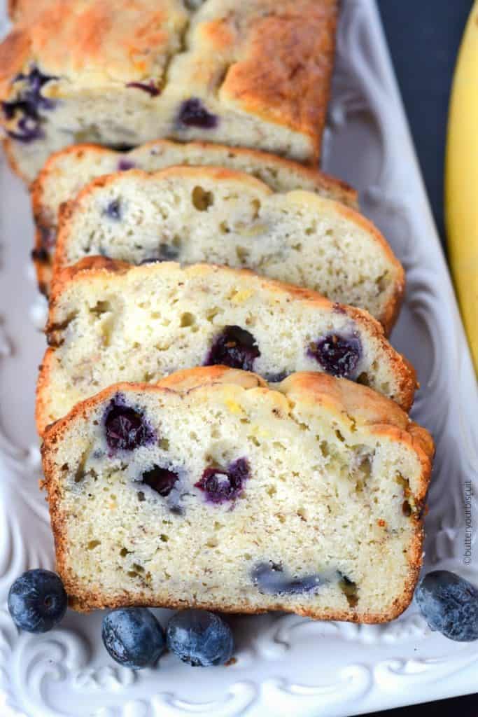 Banana Blueberry cream cheese bread sliced on a white platter