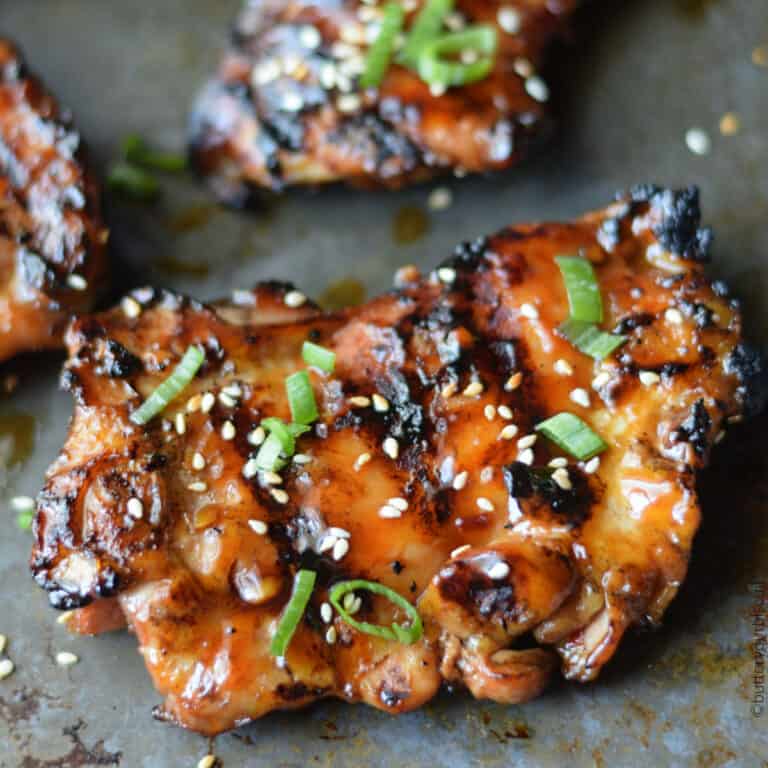 Chicken thighs on a baking sheet.