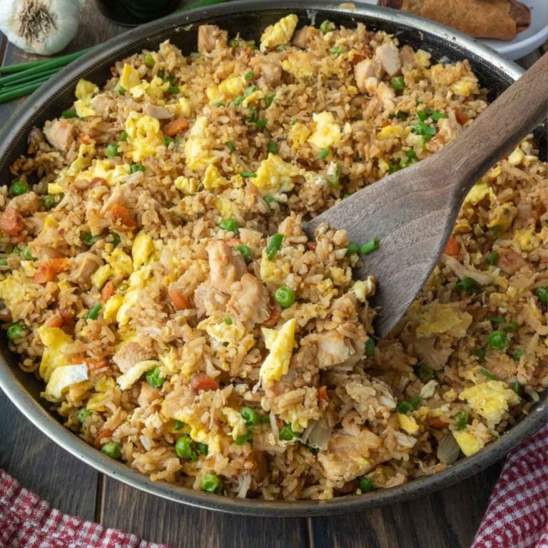 A spatula scooping out dome chicken fried rice.
