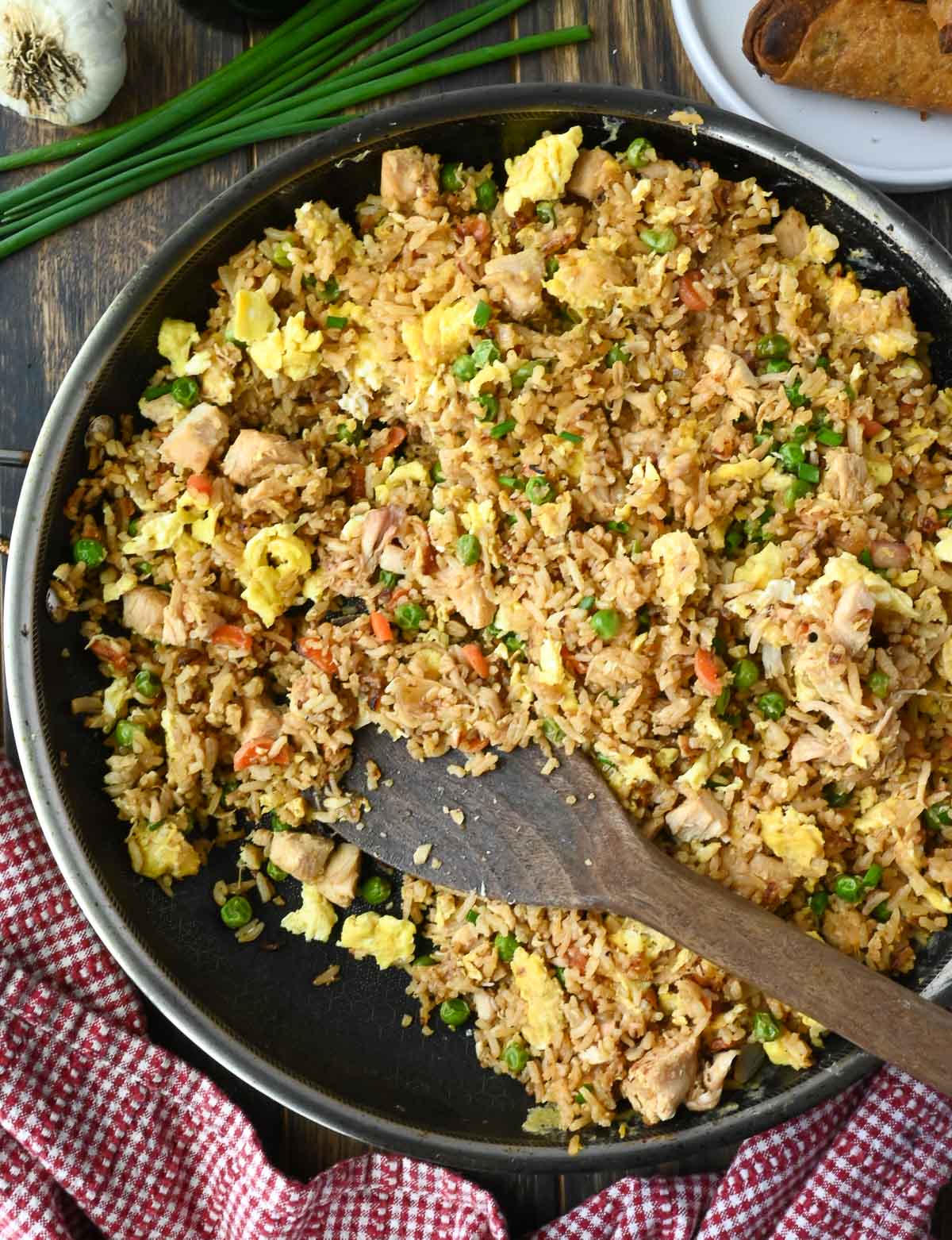 Chicken fried rice in a skillet with a spatula.
