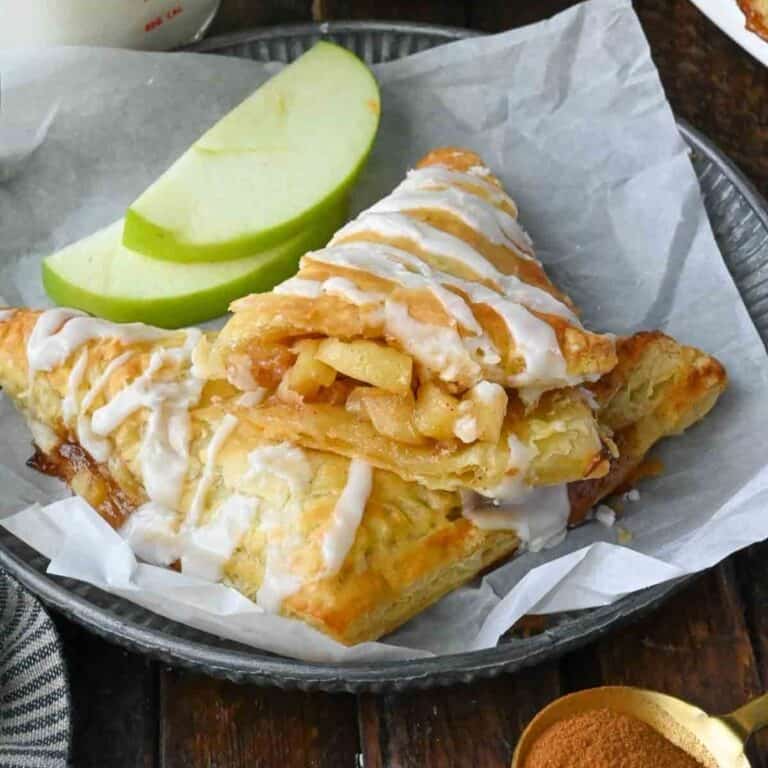 Apple pie turnover with puff pastry on a plate.