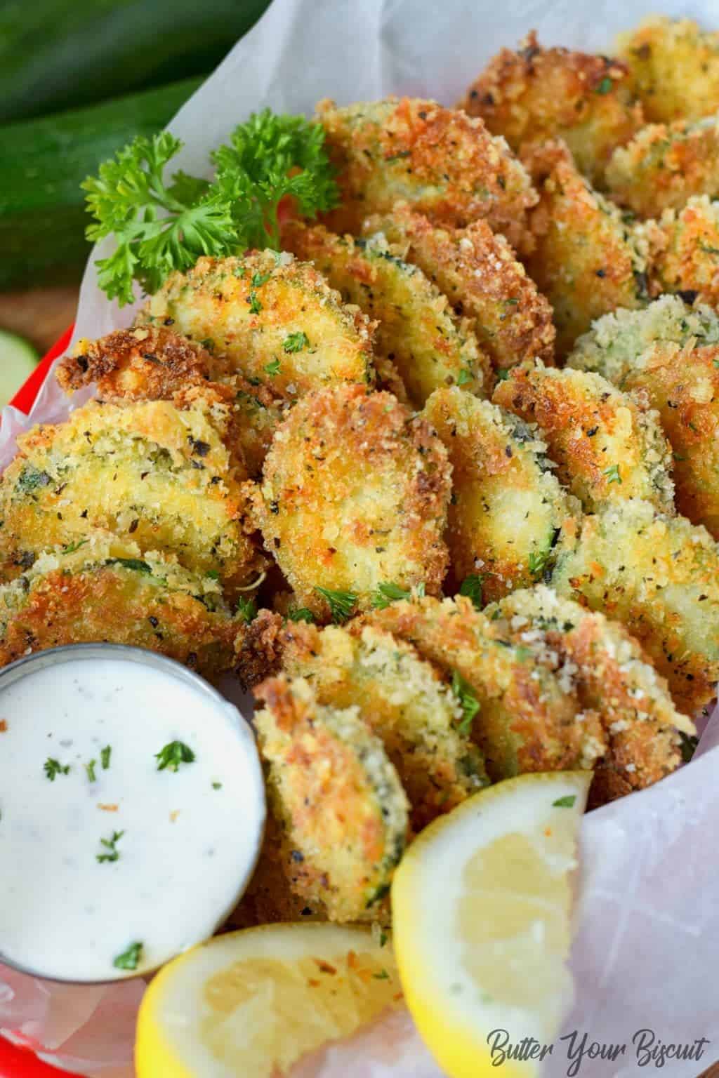 A close up of food, with Zucchini Parmesan crisps.