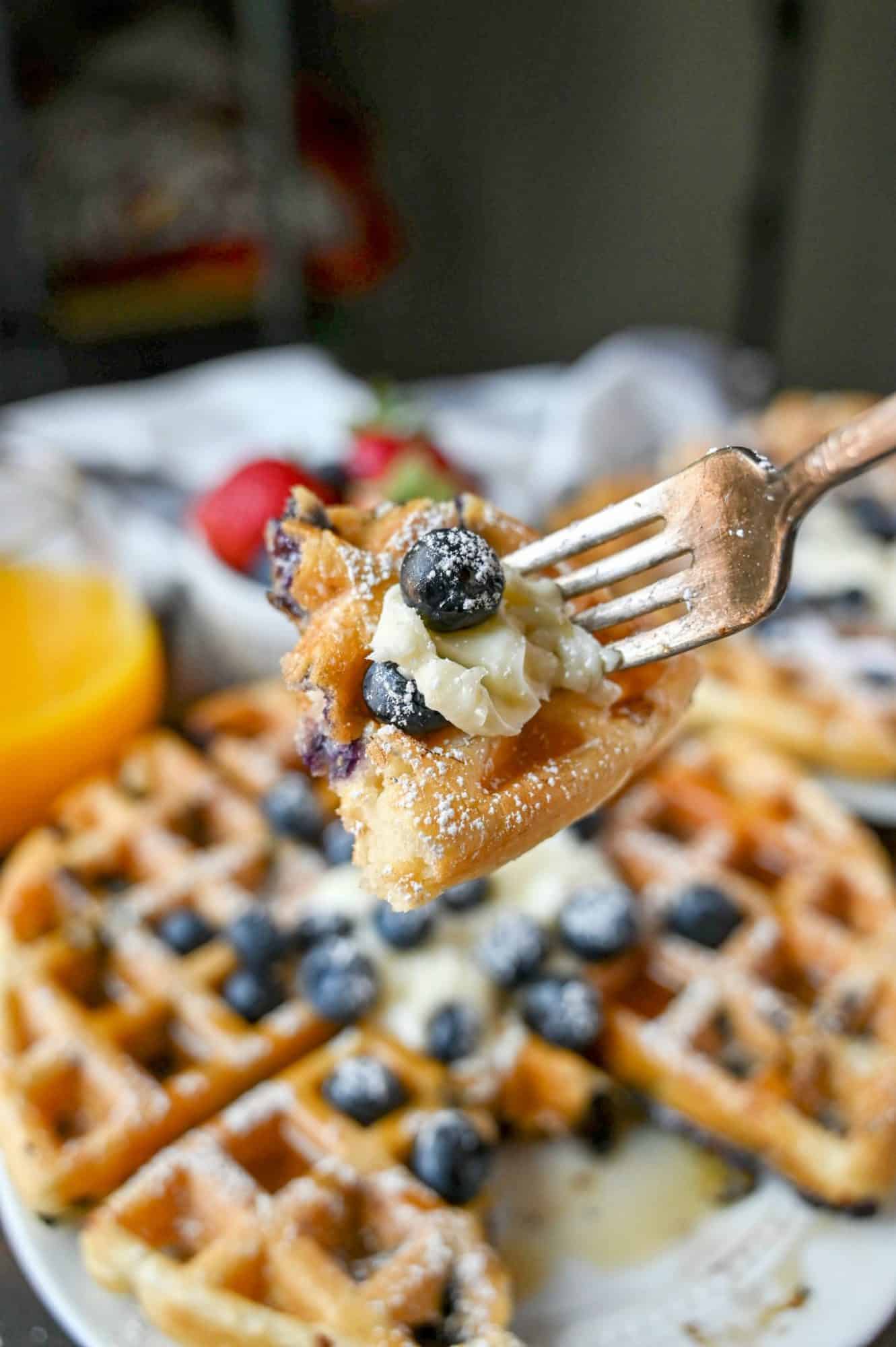A bite of the blueberry waffle on a fork.