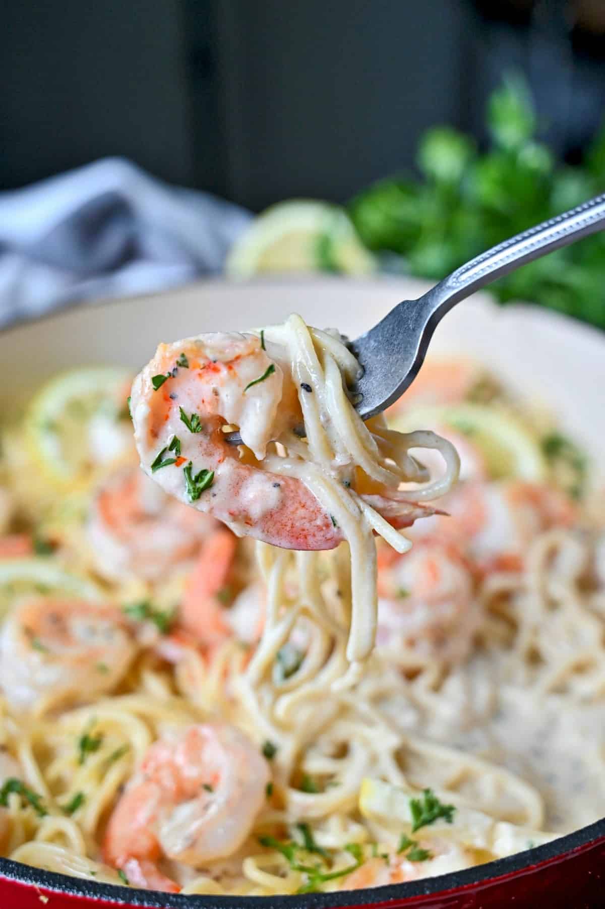 Shrimp pasta being picked up with a fork.