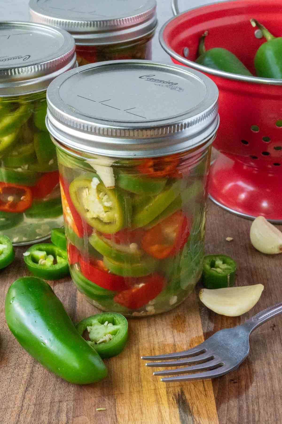 a jar of pickled jalapenos with a lid on it.