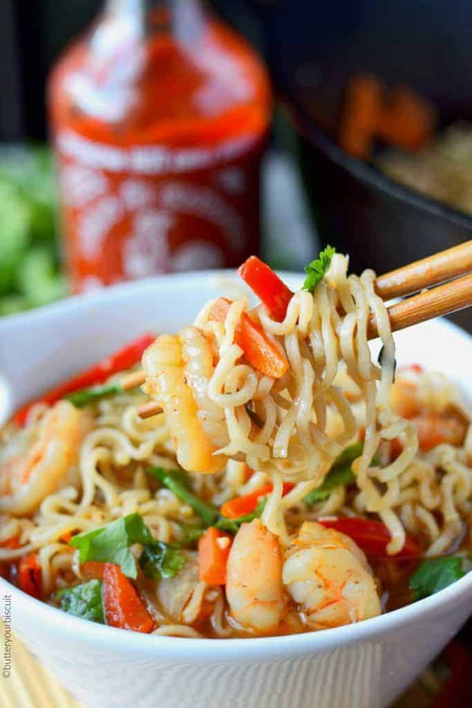 Spicy shrimp ramen bowl on chopsticks