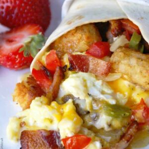 A close up of food on a plate, with Breakfast burrito