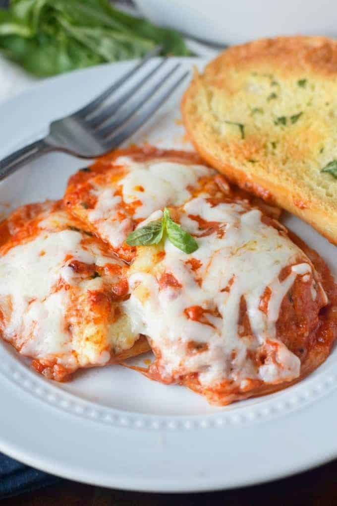 A plate with ravioli and garlic bread.