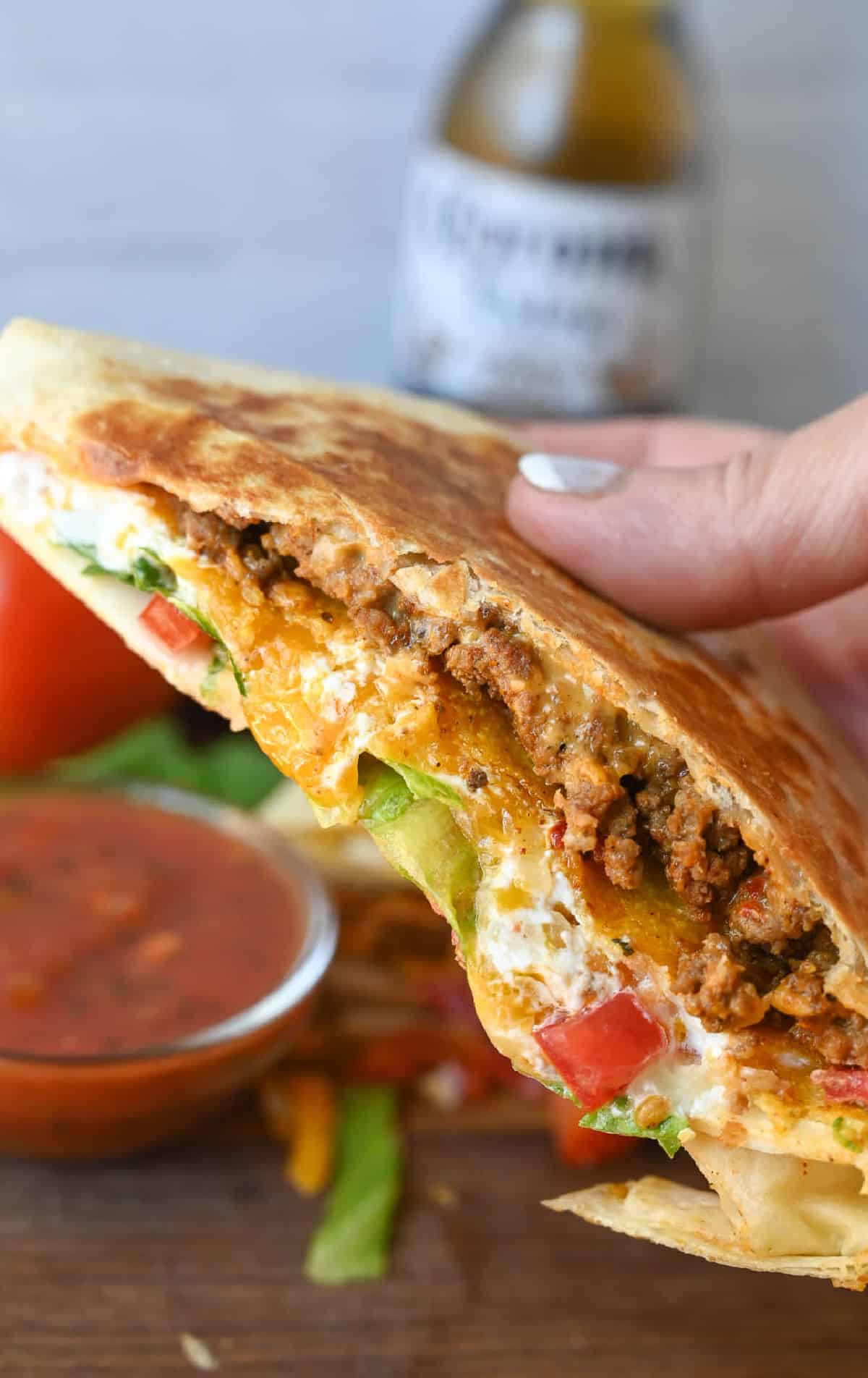 A crunch wrap being held.