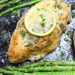 sheet pan lemon herb chicken on a baking sheet with asparagus
