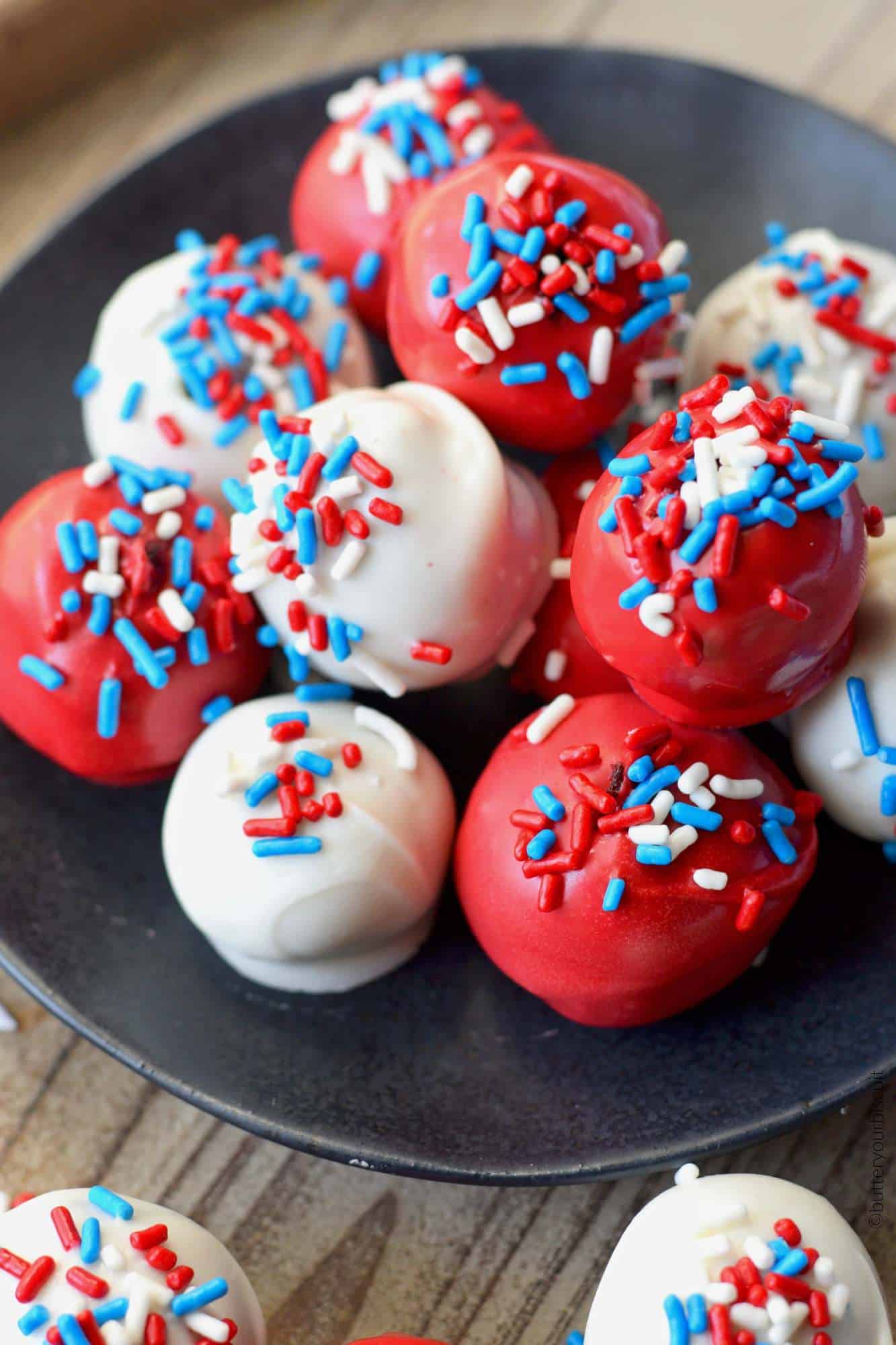 Patriotic Red Velvet Cake Balls on a black plate.