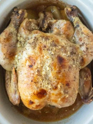 A whole chicken cooked in a slow cooker.