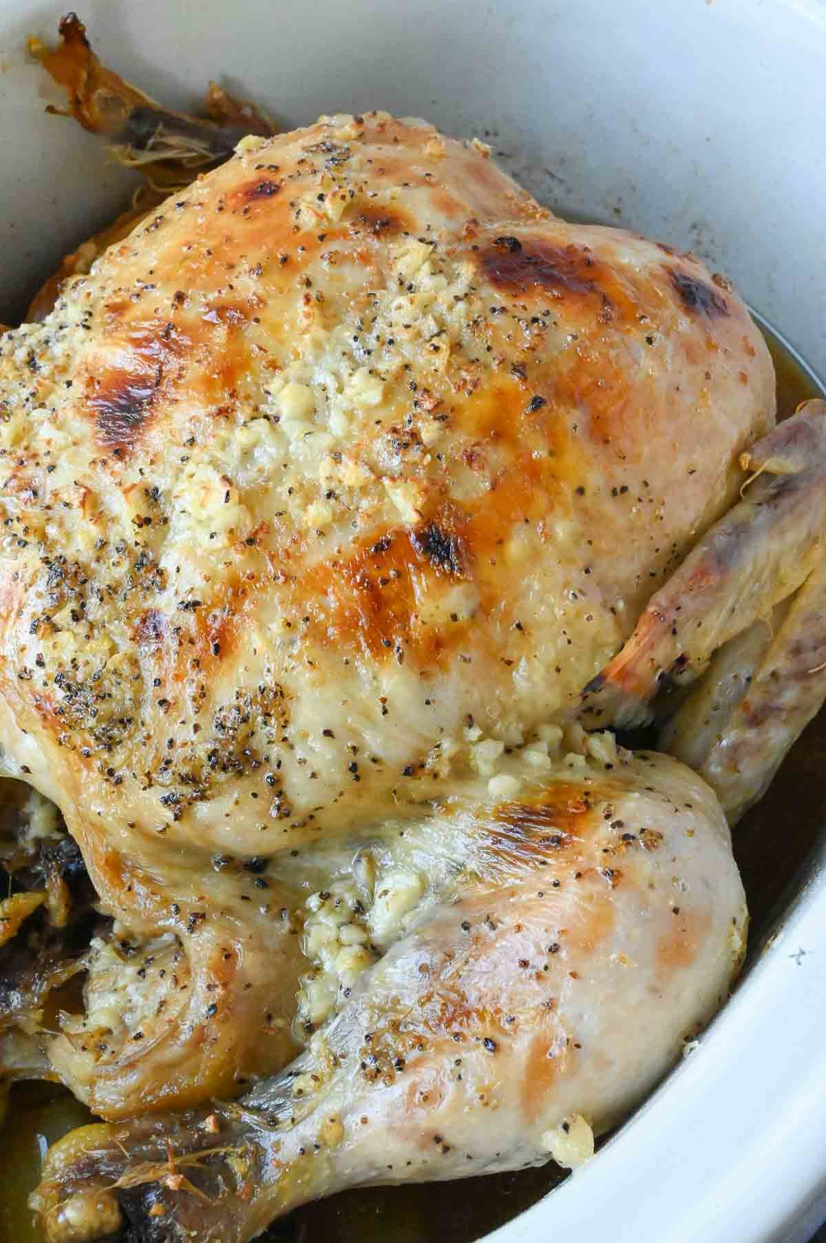 A whole chicken cooked in a slow cooker.