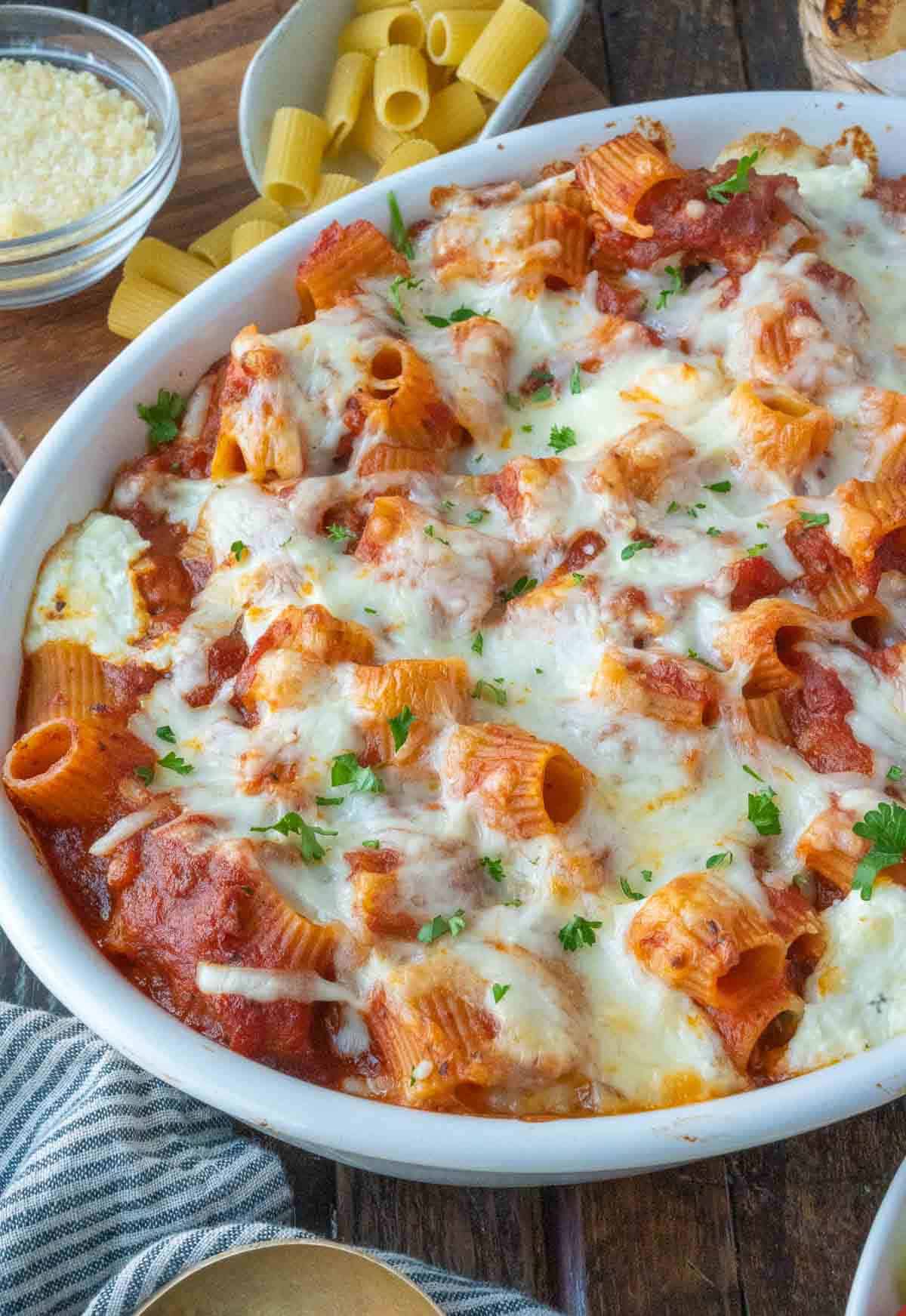 Spicy Italian sausage baked ziti in a casserole dish.