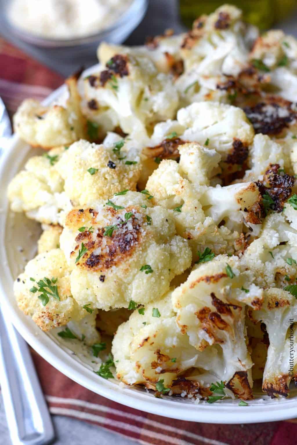 Garlic parmesan roasted cauliflower in a white bowl.