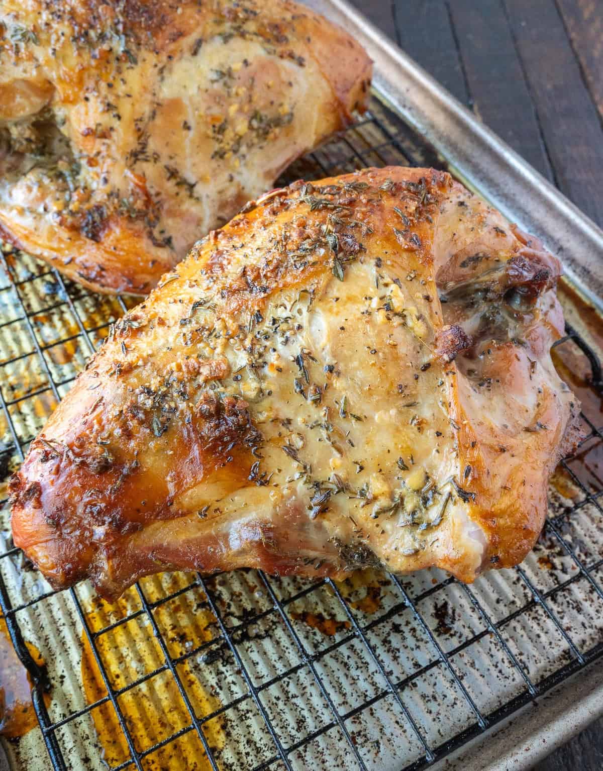 Roasted turkey breast on a baking sheet.