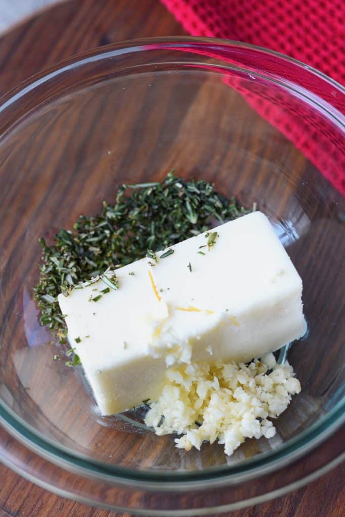 Butter and fresh herbs in a bowl.