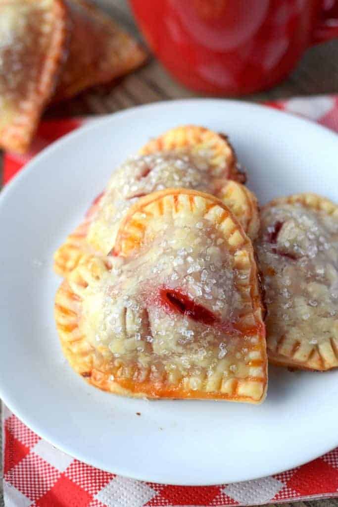 Heart shaped cherry hand pies on a white plate