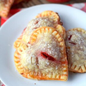 Heart shaped cherry hand pies on a white plate
