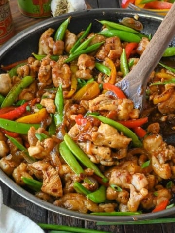 Sweet and spicy chicken stir fry in a skillet.