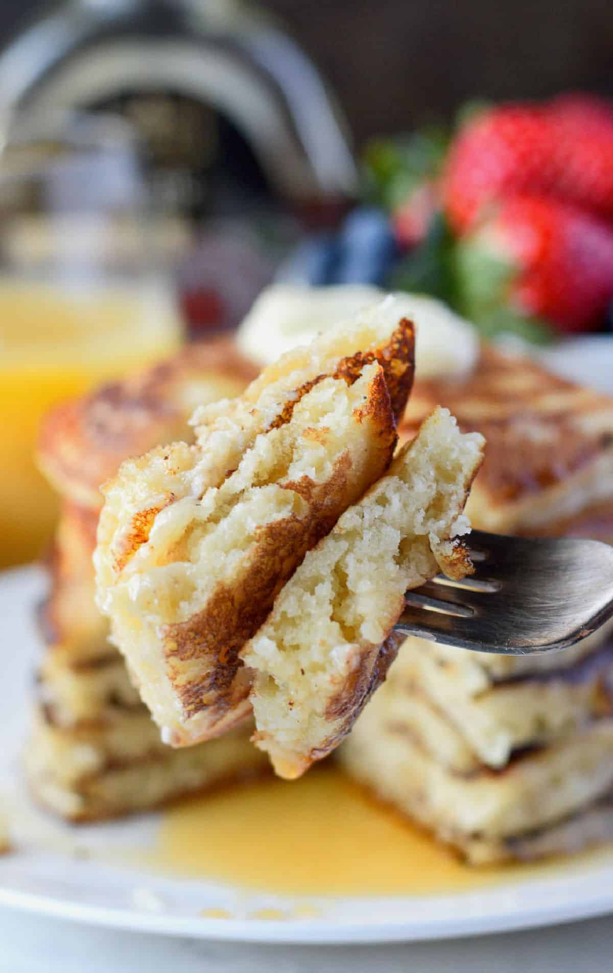 A bite of pancakes on a fork.