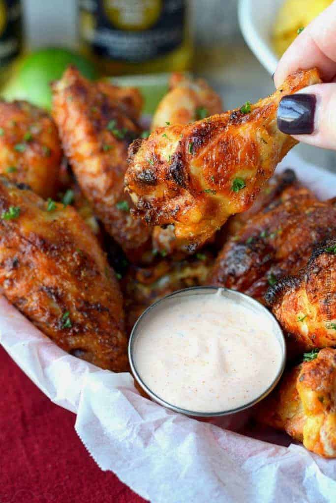 Spicy ranch chicken wings dipping in dirty ranch sauce 