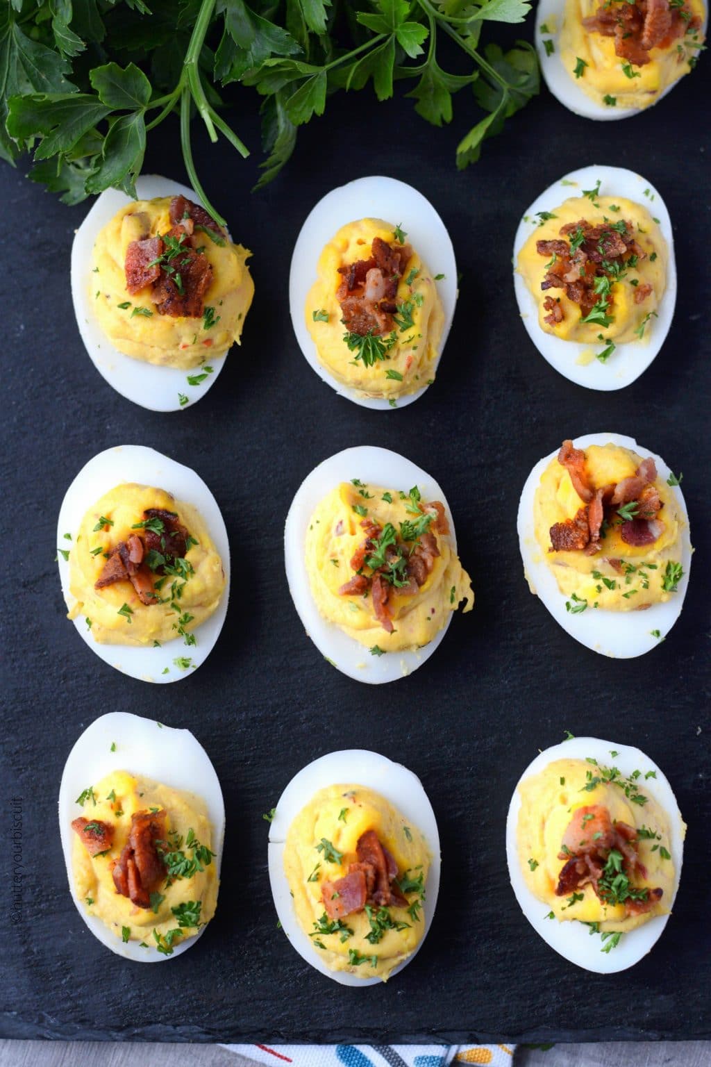 Chipotle bacon deviled eggs on a black serving dish