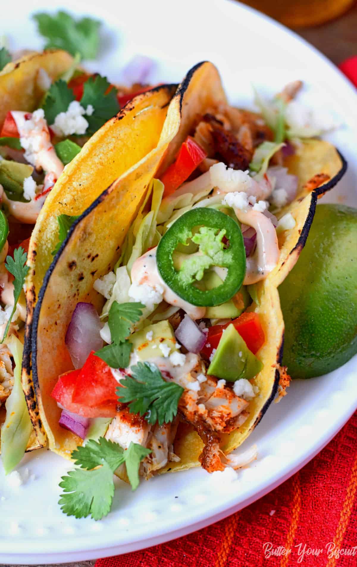 Fish taco next to a lime.