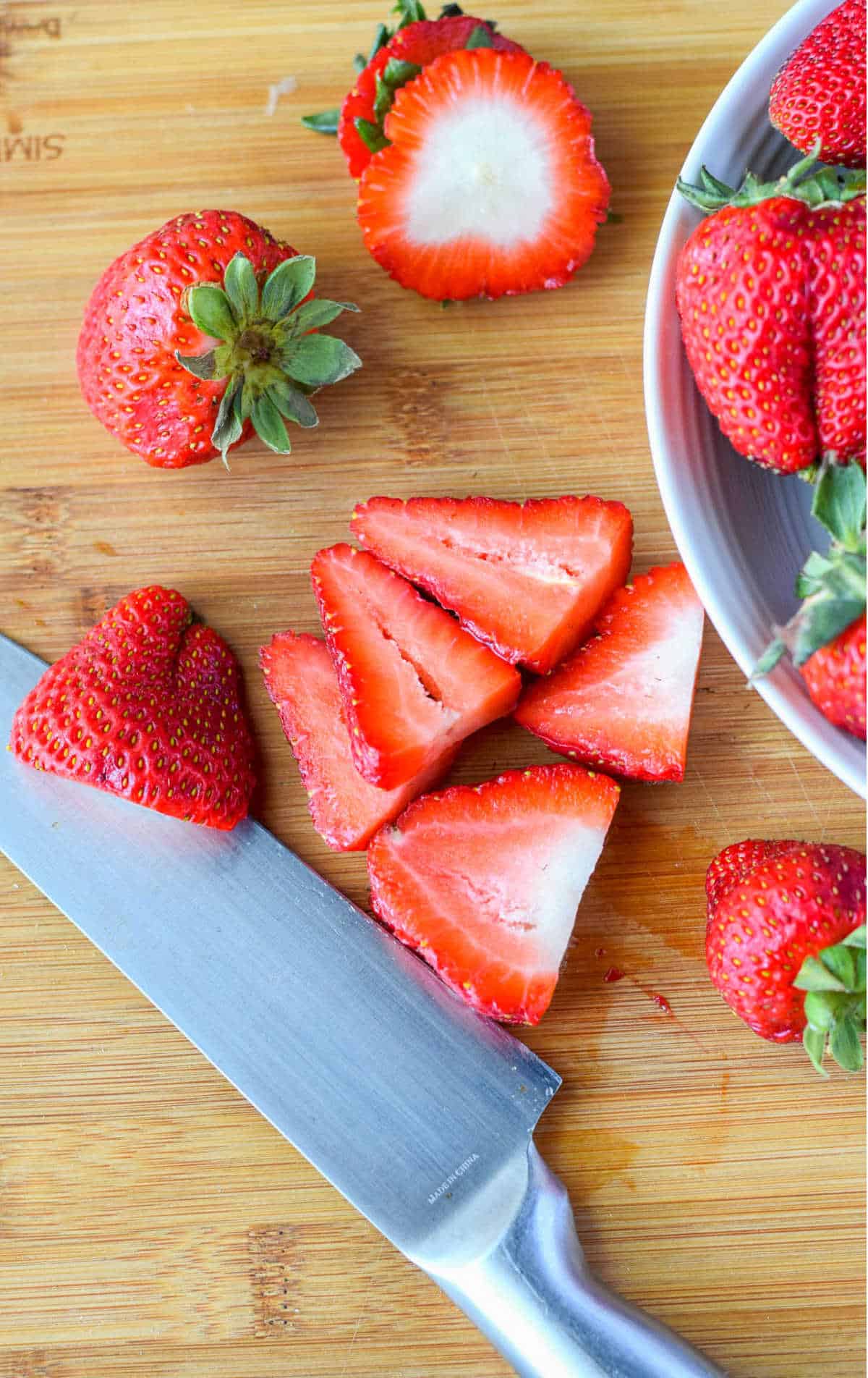 Strawberries being sliced up.