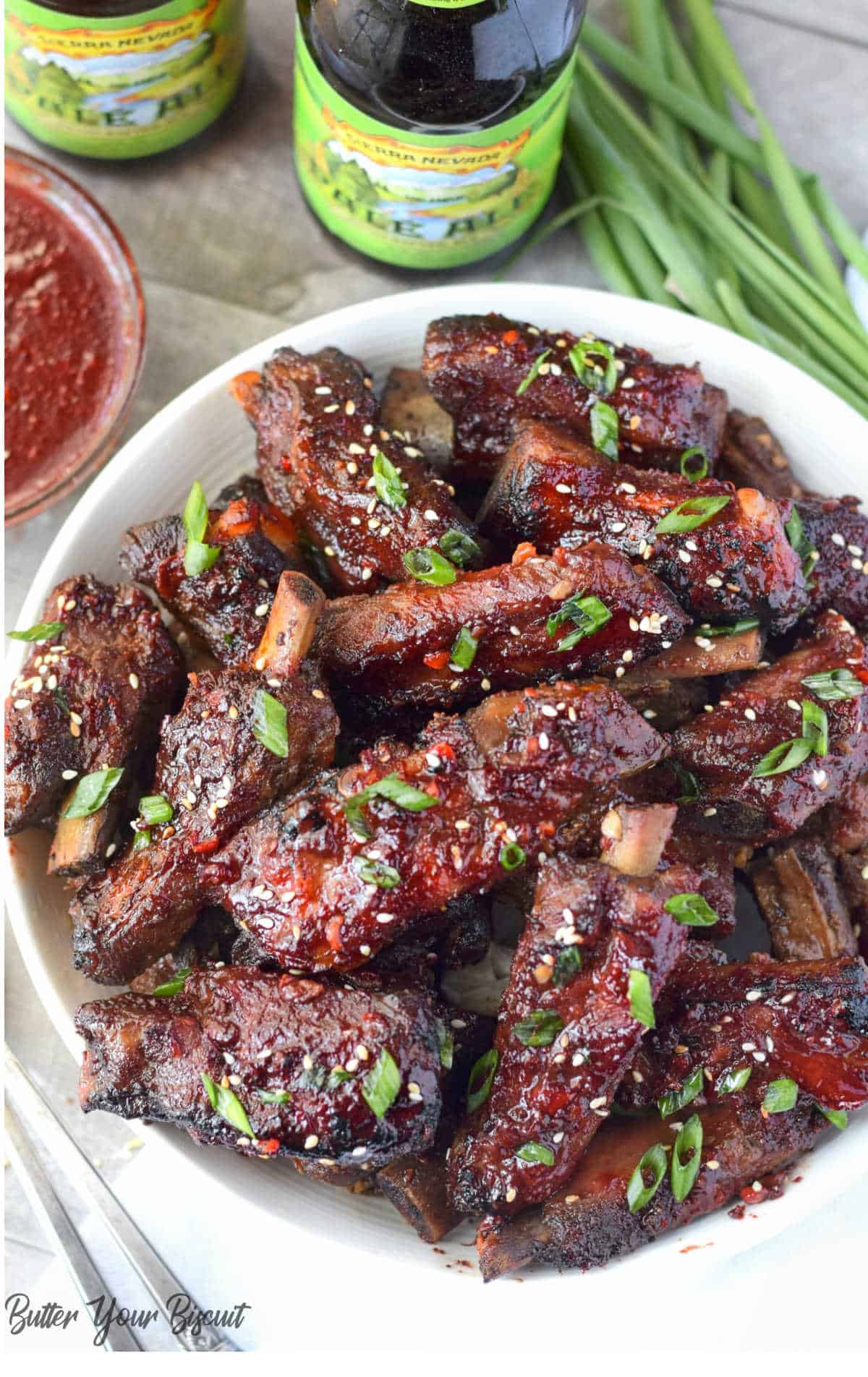 Ribs placed in a serving bowl with green onions on 