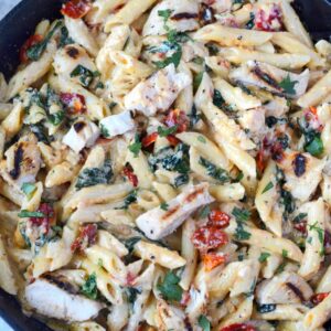 tuscan chicken pasta in a cast iron skillet