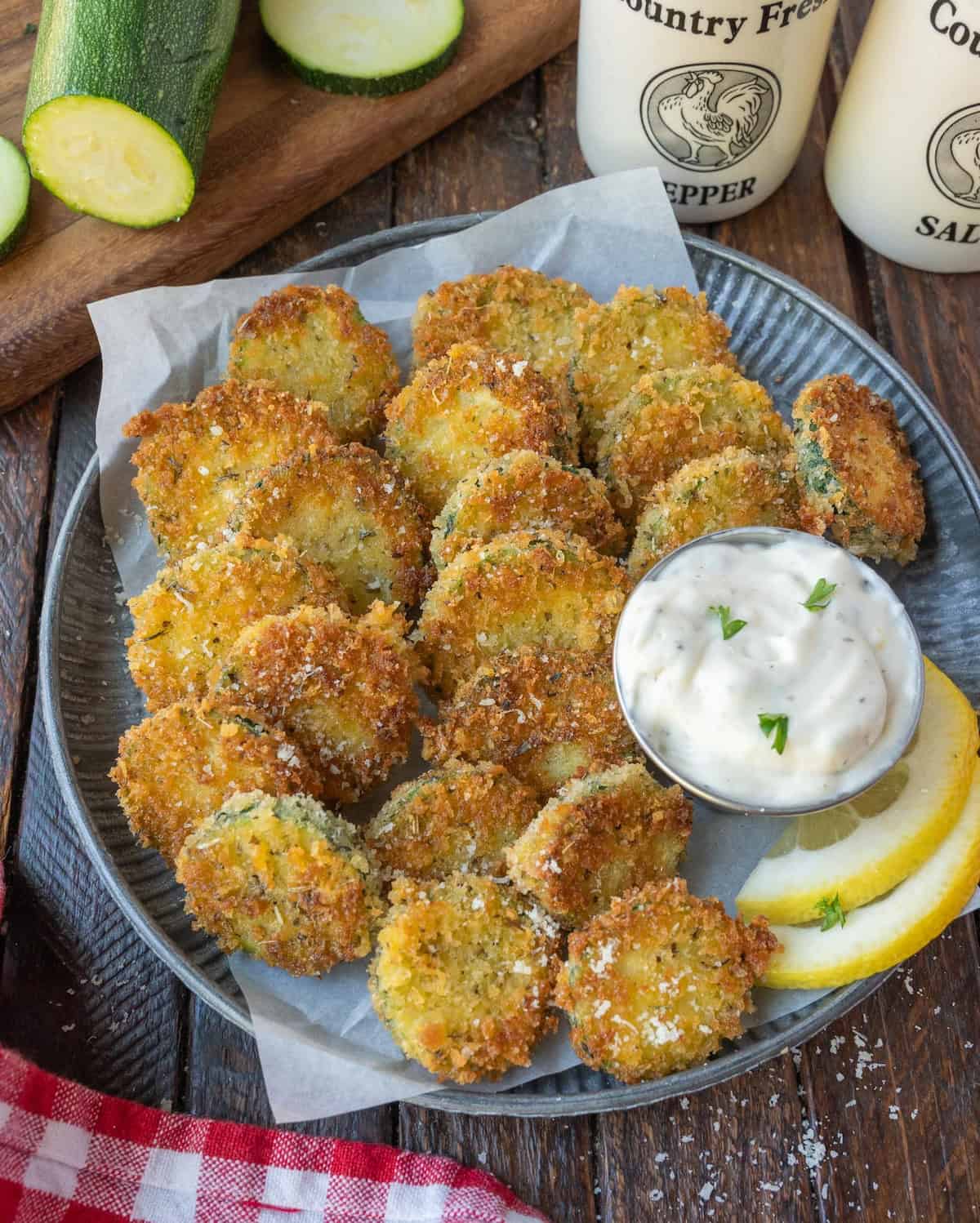 zucchini crisps on a plate with ranch dip.