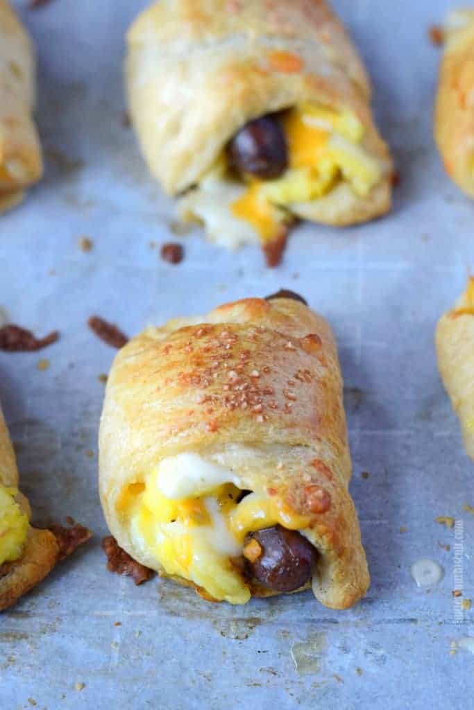 sausage egg cheese breakfast croissant roll up on a baking sheet right out of the oven