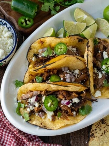 Pork carnita tacos on a platter.