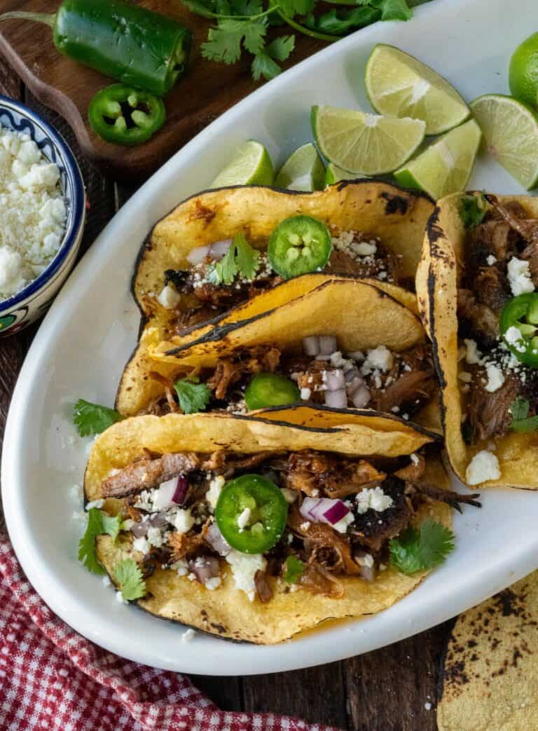 Pork carnita tacos on a platter.