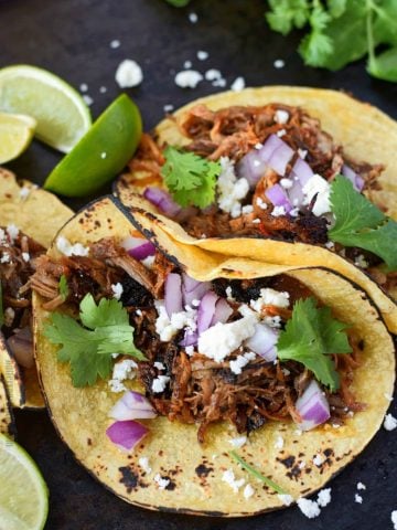 A plate of food, with Taco and Carnitas