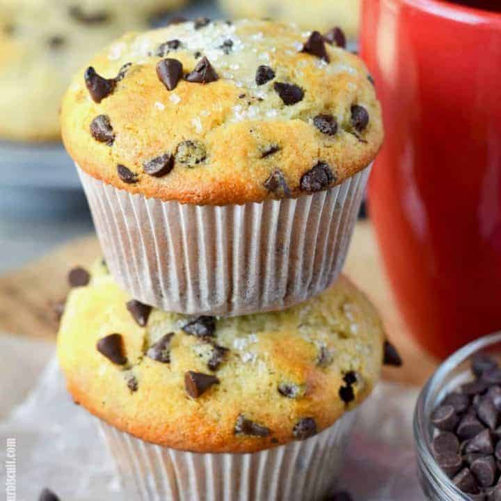 sour cream chocolate chip muffins stacked with a red coffee cup