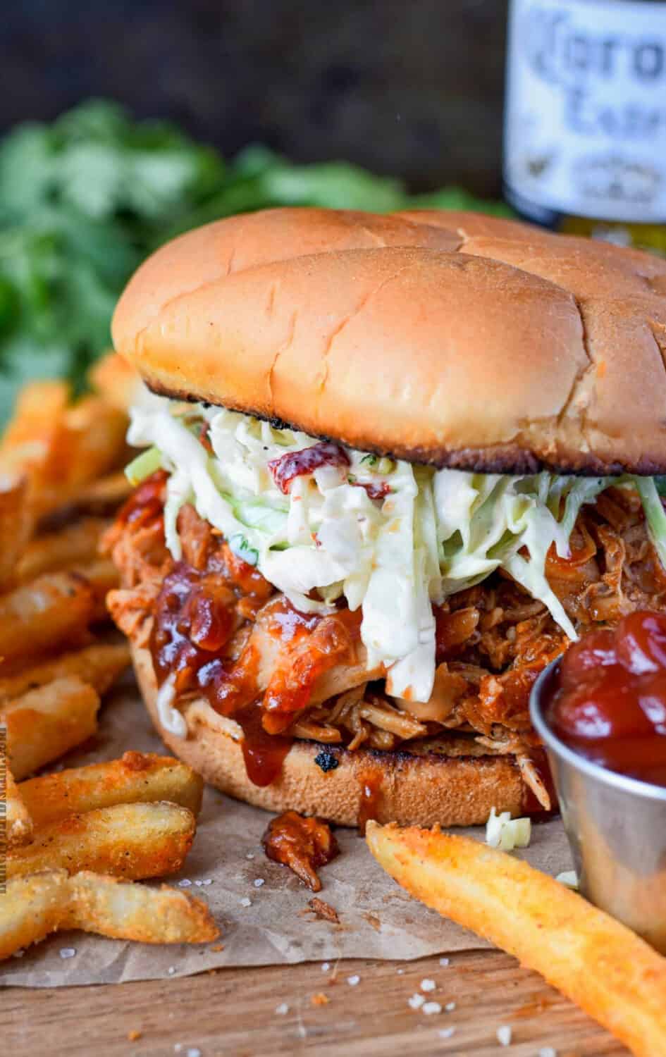 Chicken sandwich with fries and ketchup.