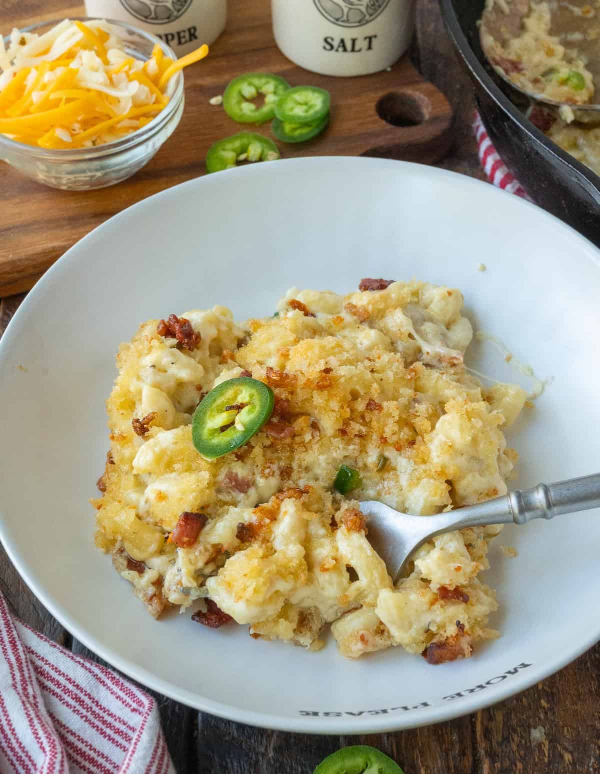 Macaroni and cheese on a plate with a fork.