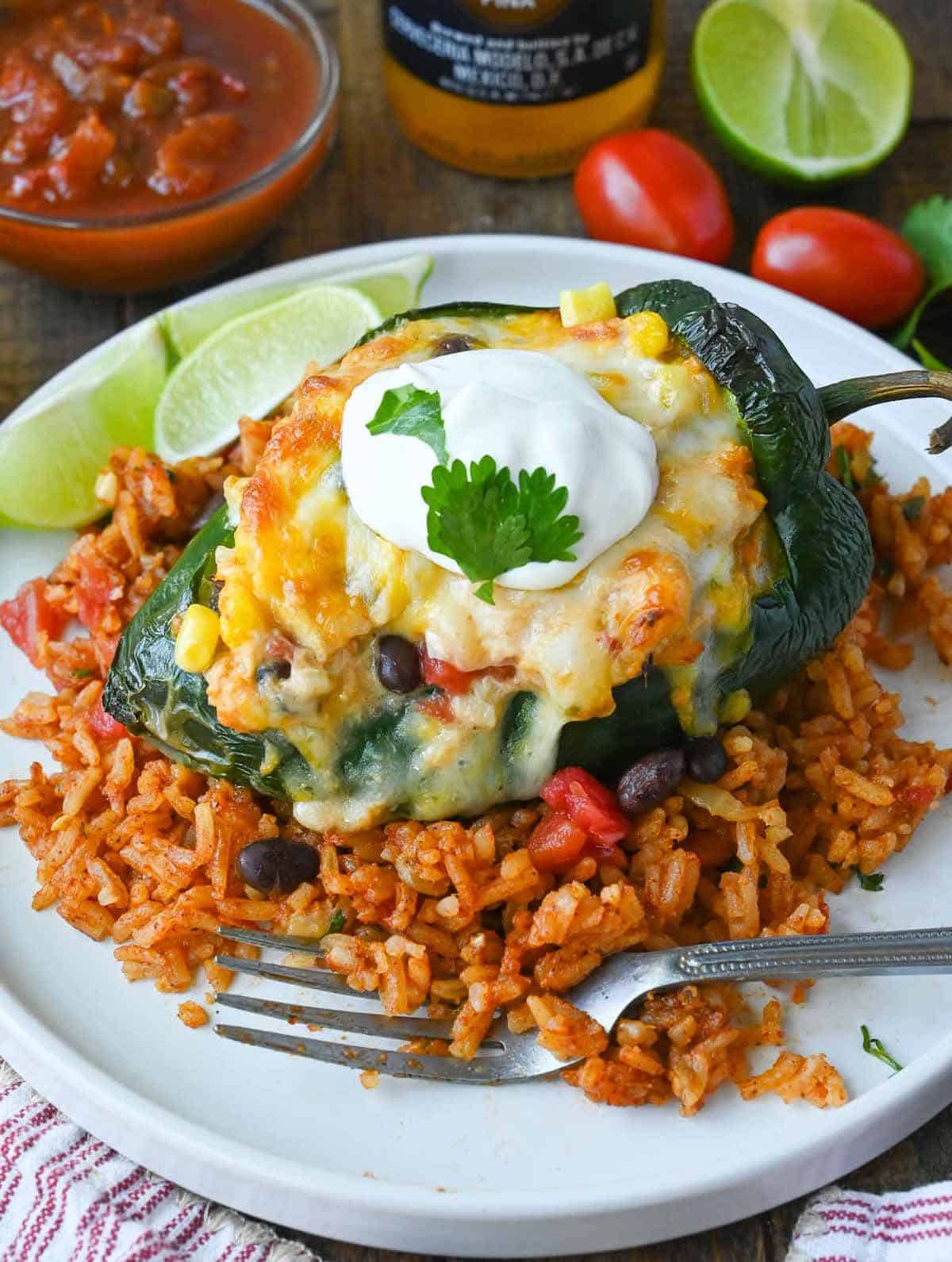 Chicken and cheese stuffed poblano pepper on top of Mexican rice.
