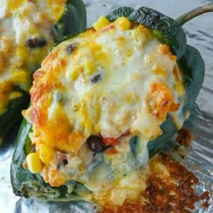 Stuffed poblano peppers on a baking sheet.