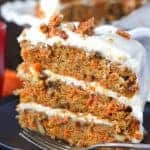 piece of carrot cake with three layers and cream cheese frosting