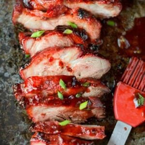 oven baked chinese bbq pork on a baking sheet sliced