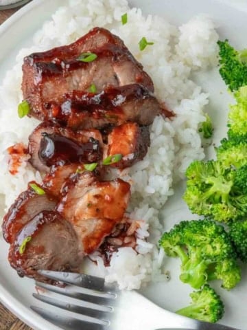 Chinese bbq pork on some white rive and broccoli.