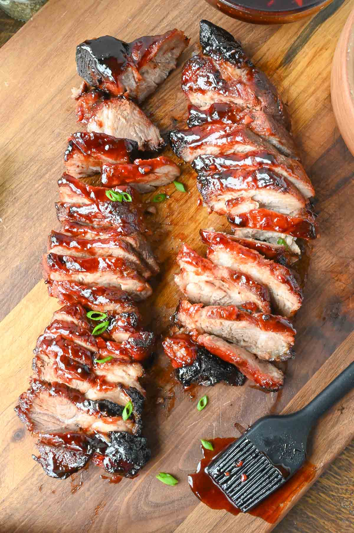 Chinese bbq pork ribs on a cutting board sliced.