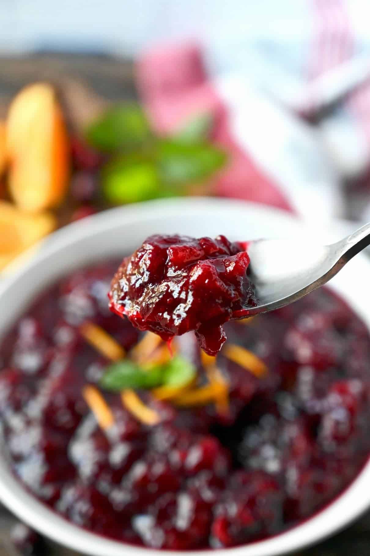 Cranberry sauce bite being picked up onto a fork.