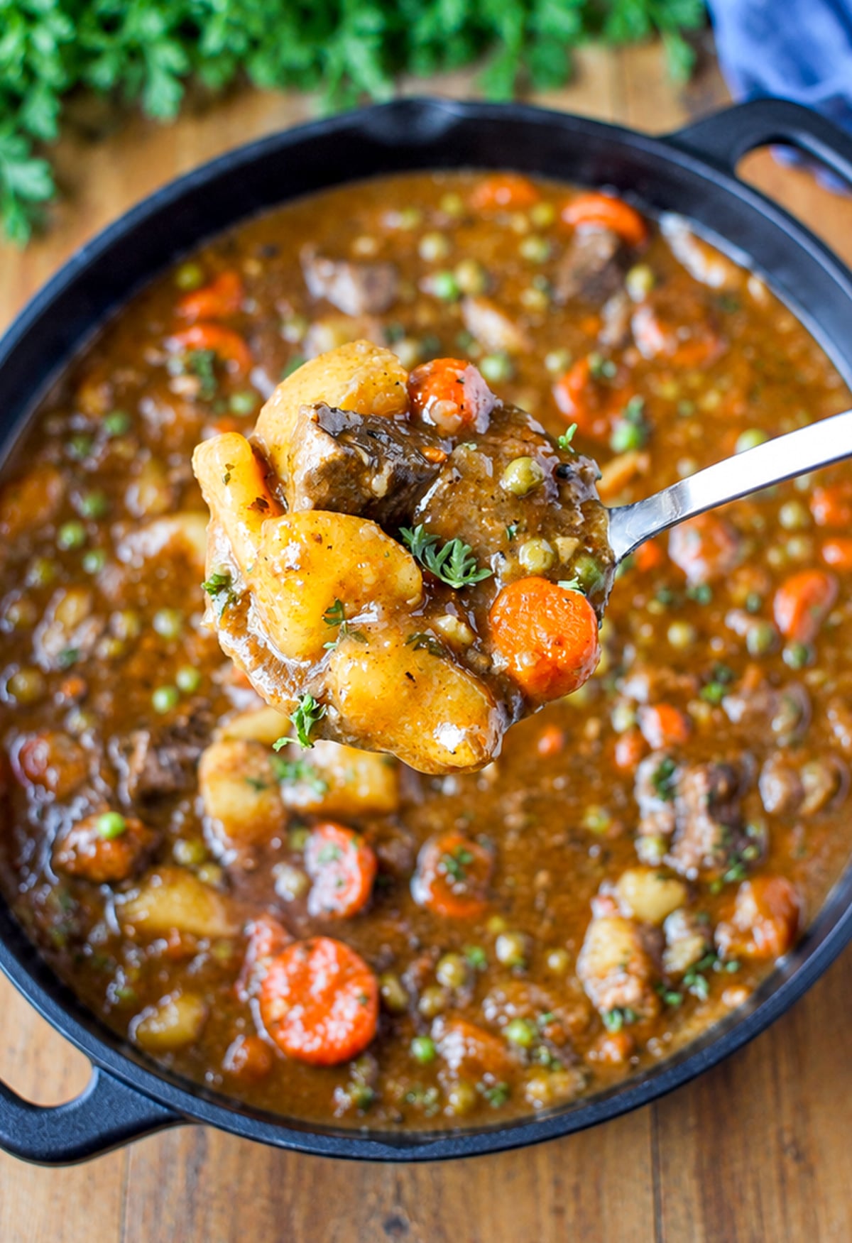 hearty beef stew in a pot with a ladle.