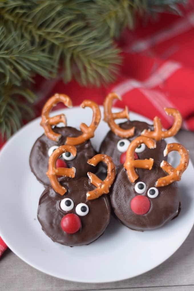 Four oreo dipped cookies decorated as reindeer.